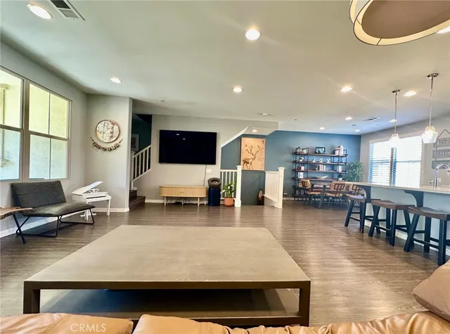 a living room with furniture a table and a large window