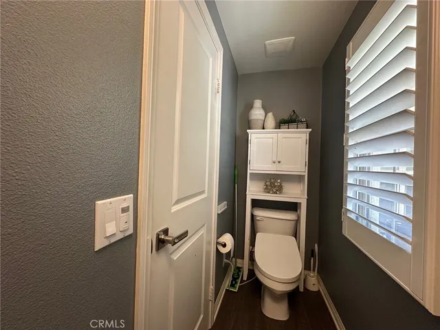 a white toilet sitting next to a bathroom sink