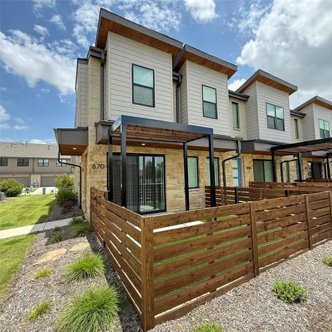 a view of a house with a wooden fence