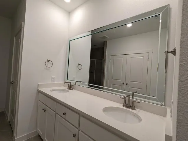 a bathroom with a glass shower door