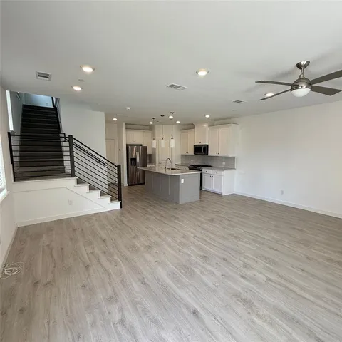 a view of kitchen with cabinets and wooden floor
