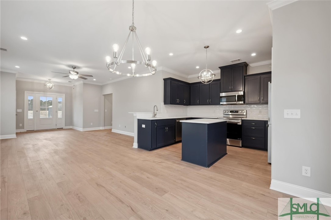 102 Owens Road Pembroke, GA 31321 - Photo 7 of 37 Kitchen is open to the dining and great room.