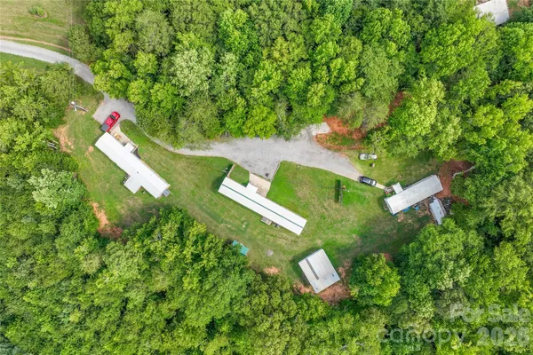 an aerial view of a house with a yard and trees