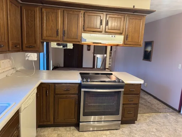 a kitchen with granite countertop a stove and a sink