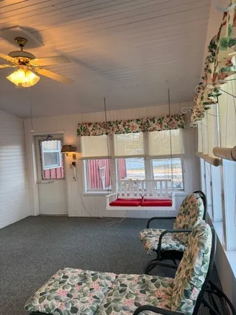 a living room with furniture and a floor to ceiling window