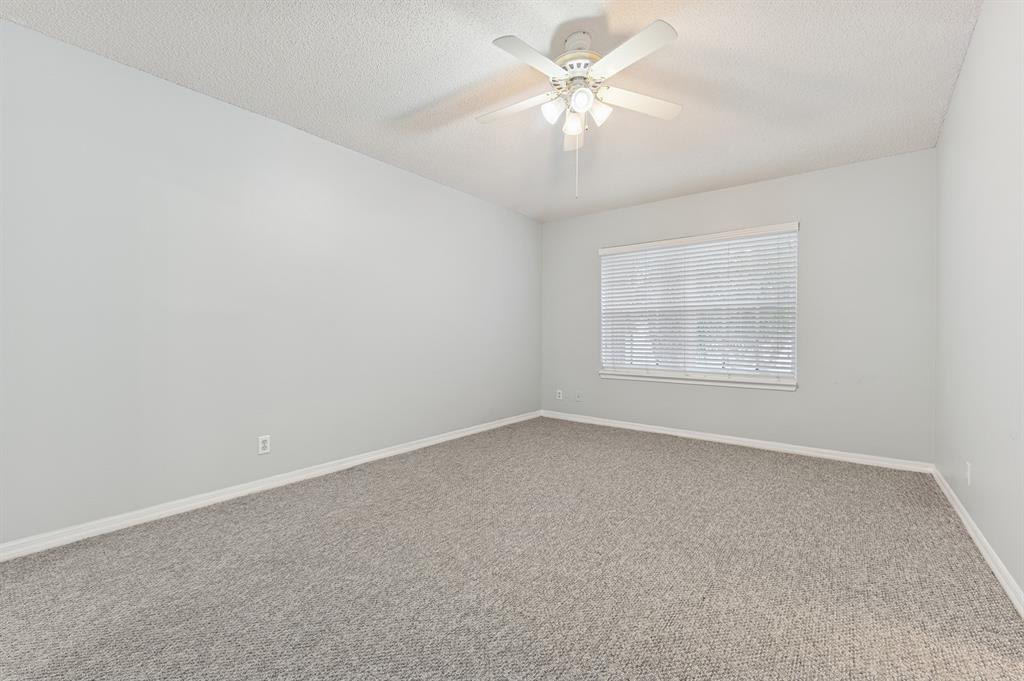6007 Red Plum Court, Unit 465 Tamarac, FL 33321 - Photo 12 of 23 an empty room with a chandelier fan and windows