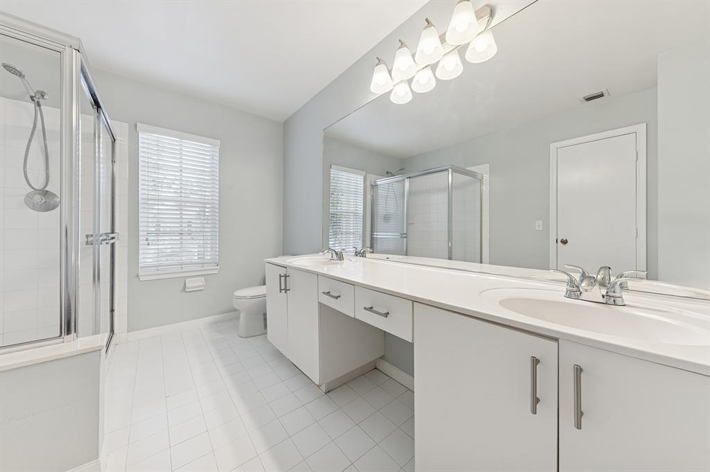 6007 Red Plum Court, Unit 465 Tamarac, FL 33321 - Photo 13 of 23 a spacious bathroom with a double vanity sink a large mirror and a bathtub