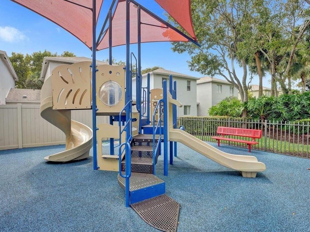 6007 Red Plum Court, Unit 465 Tamarac, FL 33321 - Photo 22 of 23 a view of playground with a slide and swing