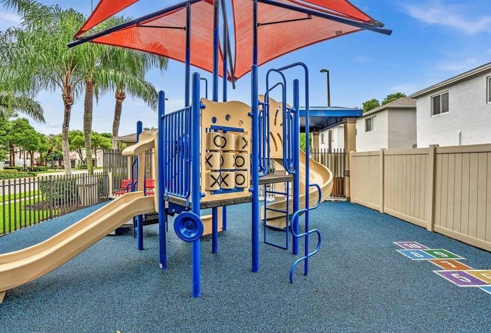 6007 Red Plum Court, Unit 465 Tamarac, FL 33321 - Photo 23 of 23 a table and chairs in front of a house