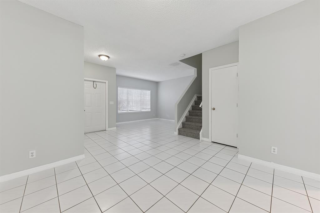 6007 Red Plum Court, Unit 465 Tamarac, FL 33321 - Photo 4 of 23 a view of an empty room and stairs