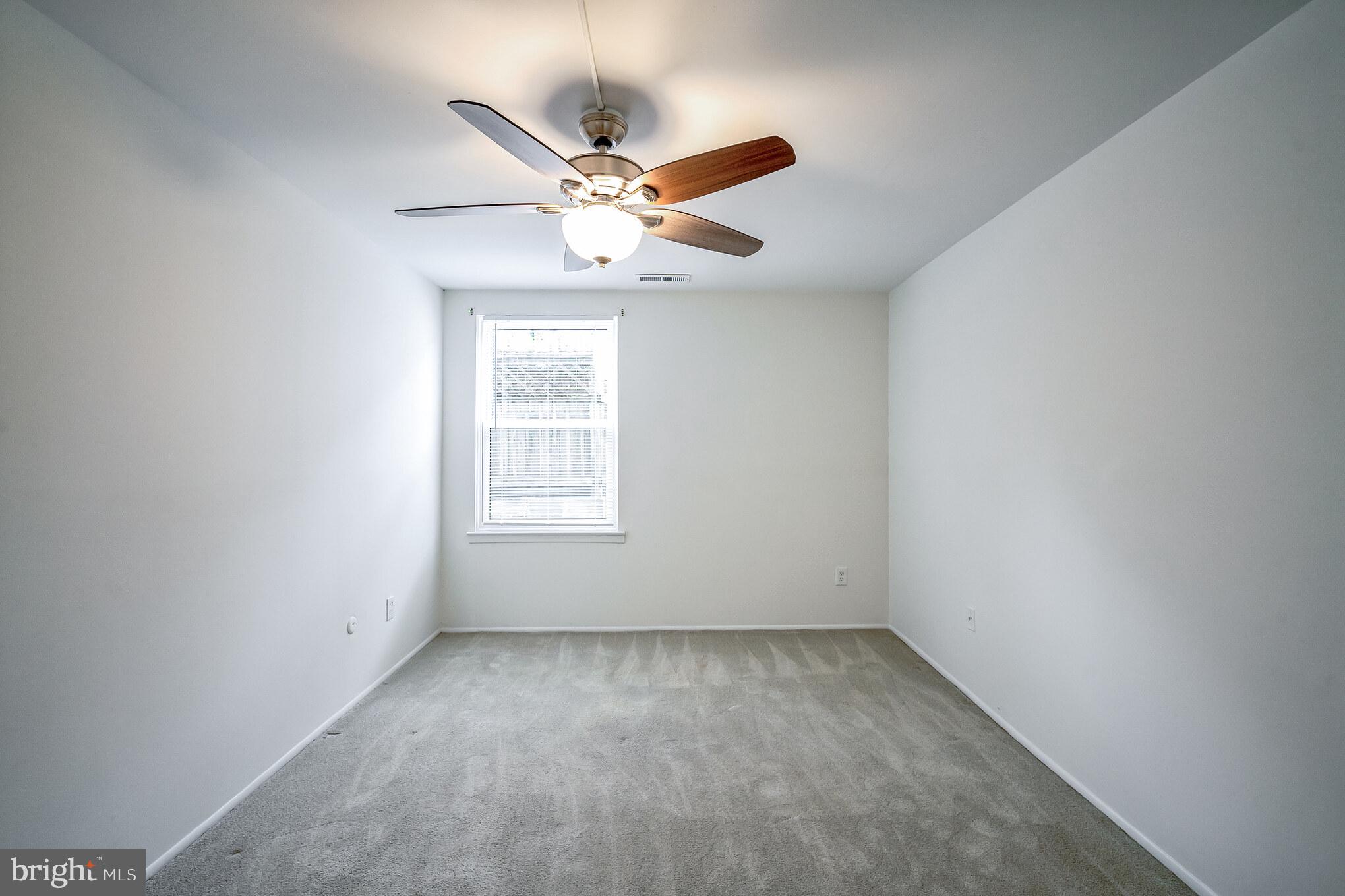 611-15 Roxborough Avenue, Unit 607A Philadelphia, PA 19128 - Photo 12 of 16 an empty room with a window and ceiling fan