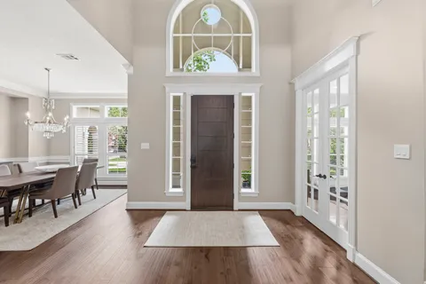 a view of a living room and a window with wooden floor