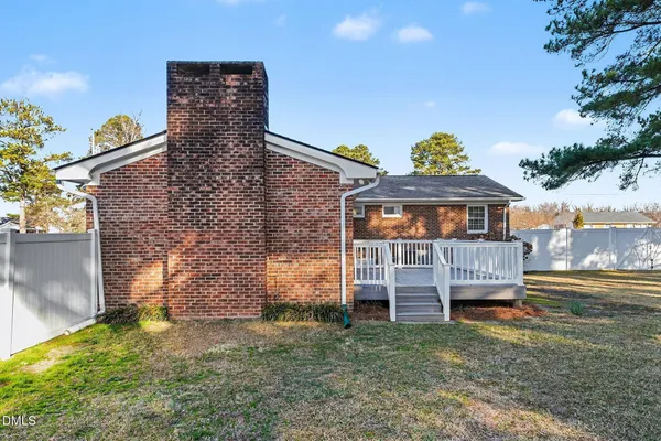 a view of a house with backyard and porch