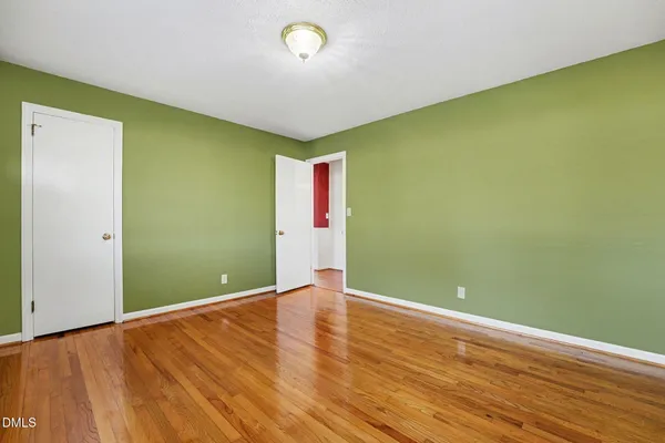 a view of a room with wooden floor and windows
