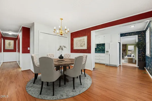 an empty room with wooden floor and fan