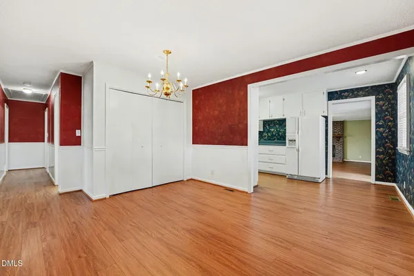 a view of a dining room with furniture wooden floor and chandelier