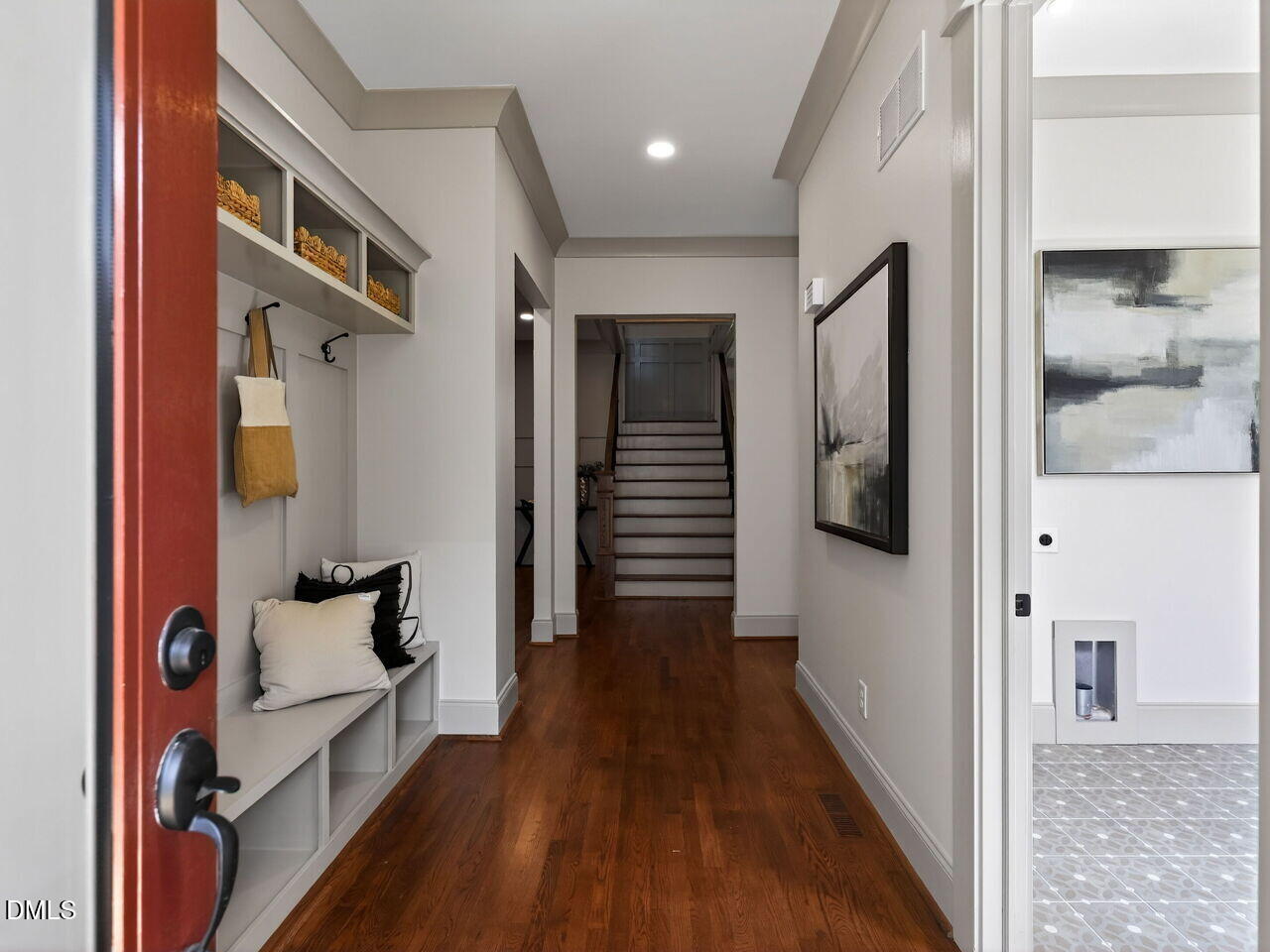 504 Tilden Street Raleigh, NC 27605 - Photo 24 of 58 a hallway with white doors wooden floor and front door