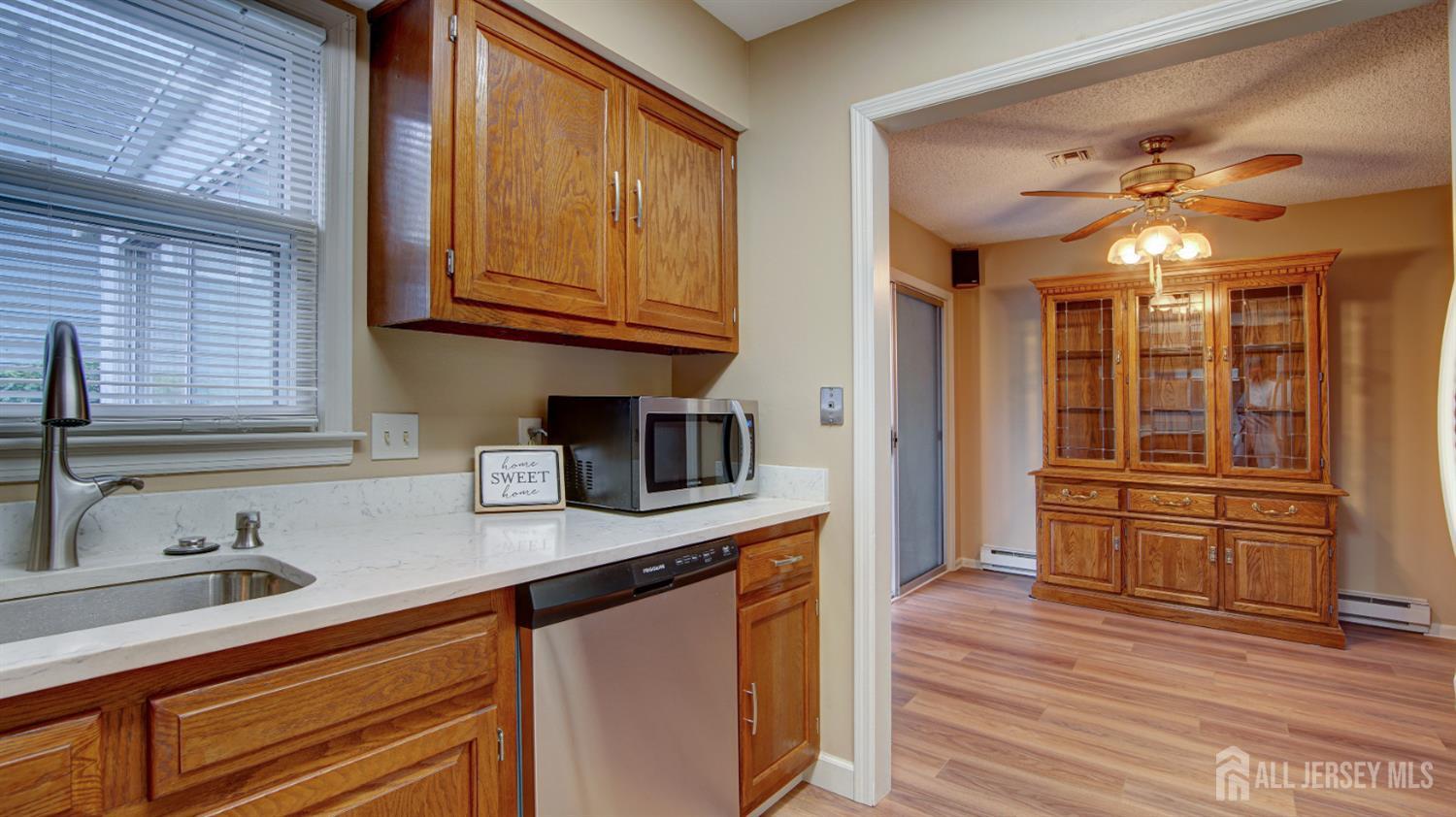 337A Old Nassau Road, Unit A Monroe Township, NJ 08831 - Photo 13 of 39 a kitchen with stainless steel appliances granite countertop a sink and dishwasher a stove top oven with wooden floor