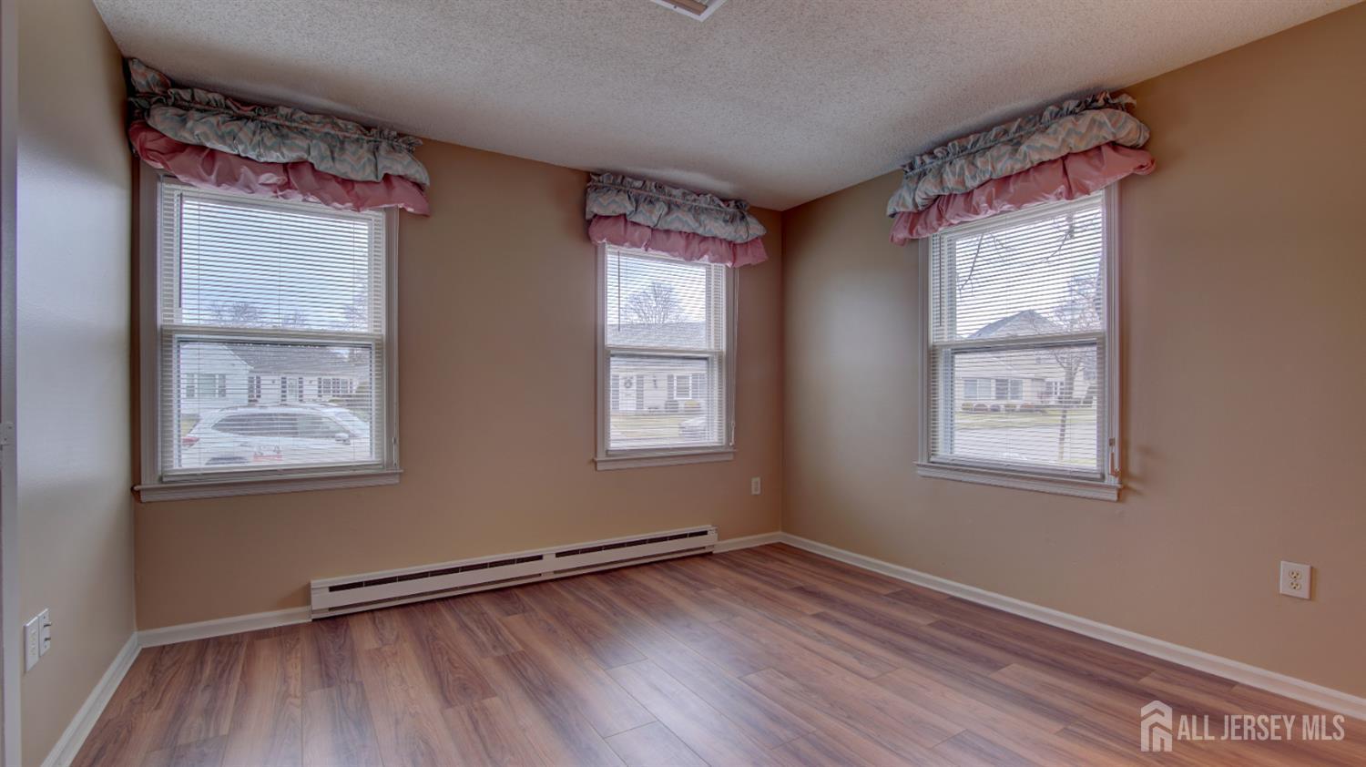 337A Old Nassau Road, Unit A Monroe Township, NJ 08831 - Photo 19 of 39 a view of an empty room with wooden floor and a window