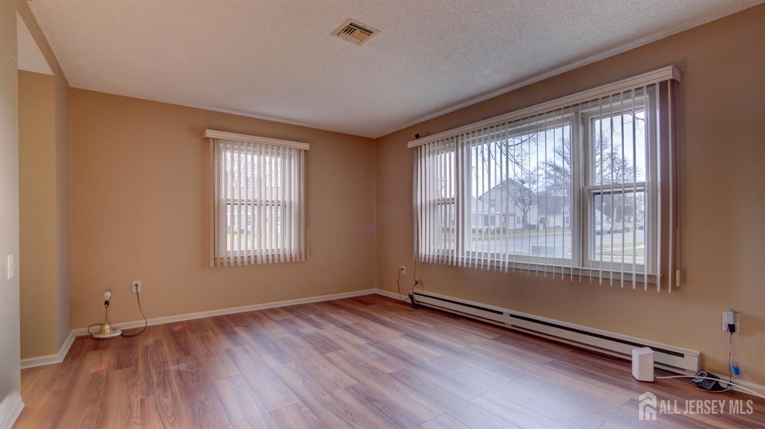337A Old Nassau Road, Unit A Monroe Township, NJ 08831 - Photo 25 of 39 an empty room with wooden floor and windows