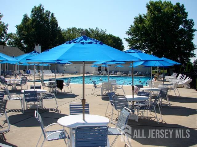 337A Old Nassau Road, Unit A Monroe Township, NJ 08831 - Photo 33 of 39 a view of patio with chairs and table under an umbrella
