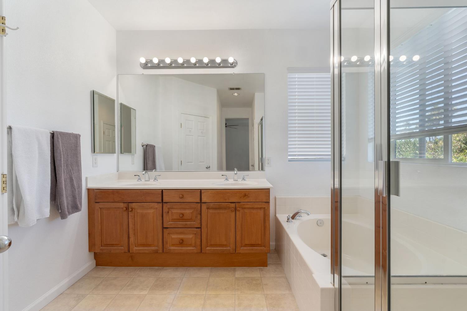 1086 Azalea Lane Concord, CA 94520 - Photo 10 of 18 a spacious bathroom with a granite countertop sink a mirror and a bathtub