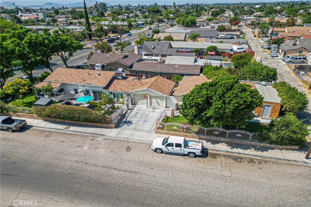 an aerial view of a house with a garden and street view