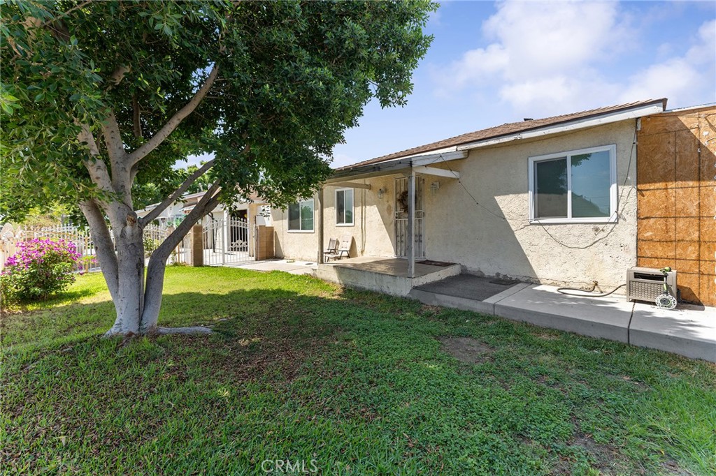 491 East C Street Colton, CA 92324 - Photo 15 of 58 a view of a house with backyard and a tree