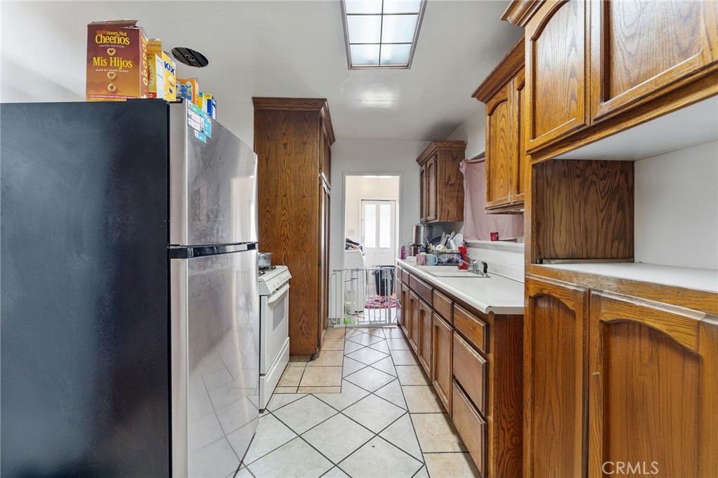 491 East C Street Colton, CA 92324 - Photo 21 of 58 a kitchen with a sink and refrigerator