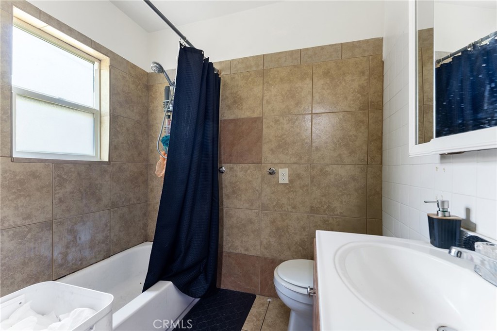 491 East C Street Colton, CA 92324 - Photo 31 of 58 a bathroom with a sink toilet and shower