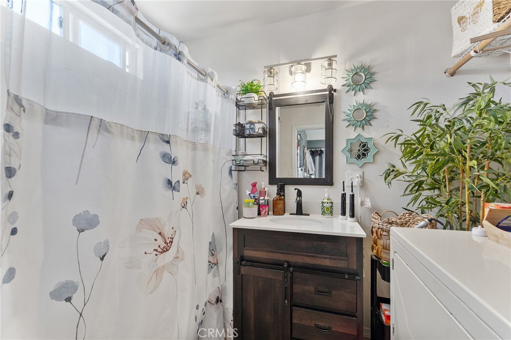 491 East C Street Colton, CA 92324 - Photo 35 of 58 a bathroom with a sink vanity and a mirror