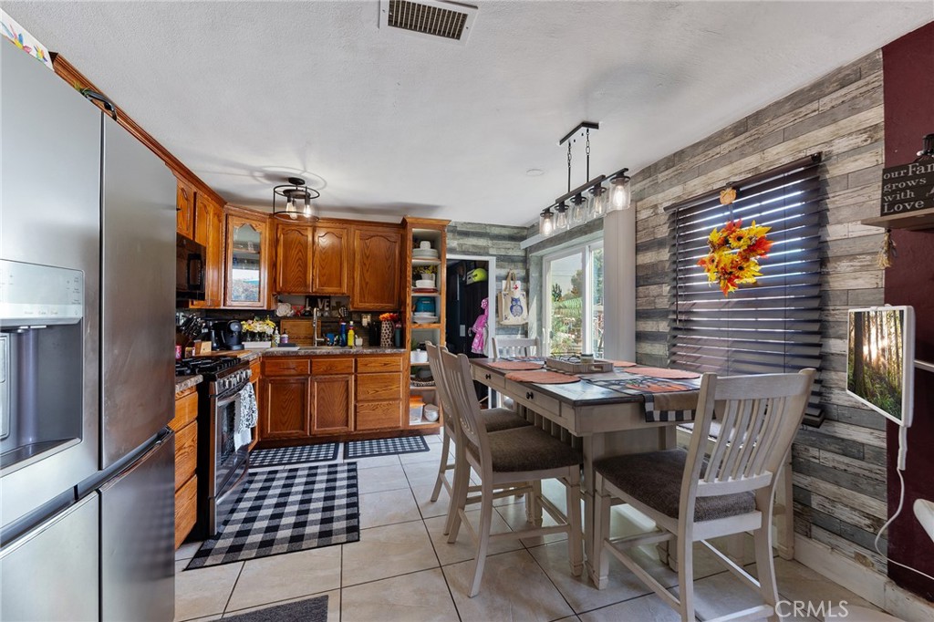 491 East C Street Colton, CA 92324 - Photo 40 of 58 a kitchen with stainless steel appliances kitchen island granite countertop a sink and cabinets