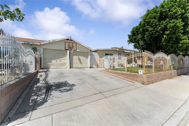 a front view of a house with a yard and plant in front of it