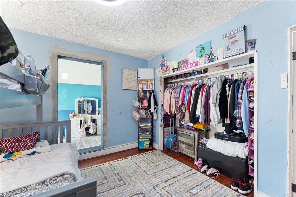 491 East C Street Colton, CA 92324 - Photo 50 of 58 a view of walk in closet with clothes and shoes