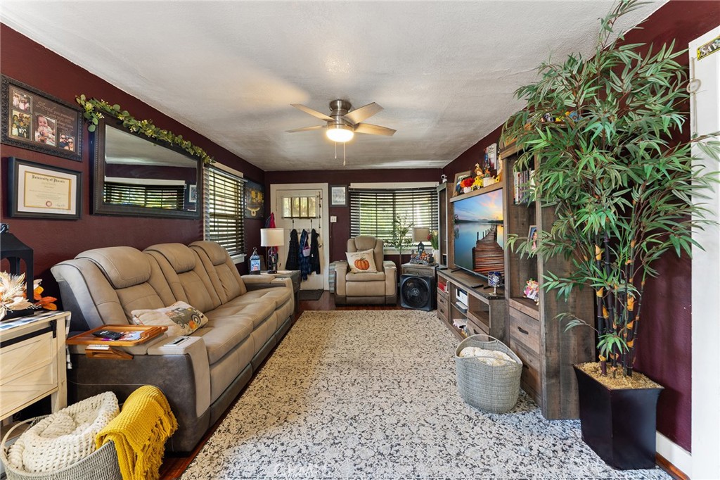 491 East C Street Colton, CA 92324 - Photo 54 of 58 a living room with furniture a chandelier and a potted plant