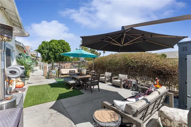 a view of a patio with a table and chairs under an umbrella