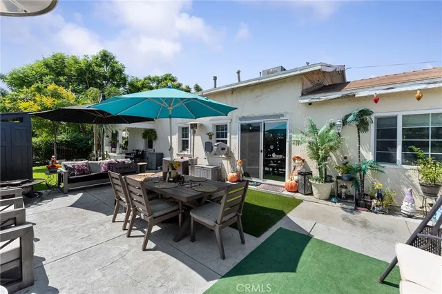 a backyard of a house with table and chairs