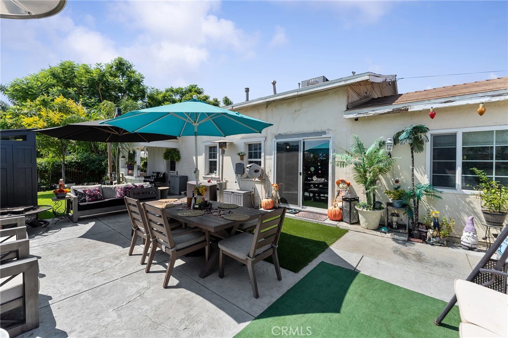 491 East C Street Colton, CA 92324 - Photo 8 of 58 a view of a patio with table and chairs under an umbrella