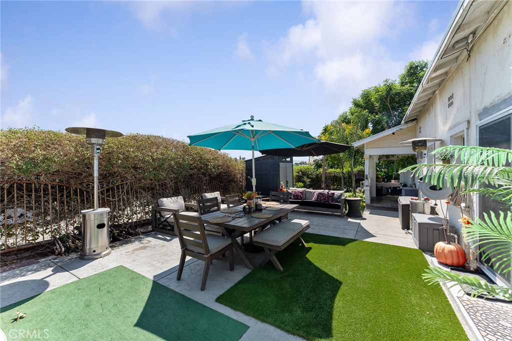 491 East C Street Colton, CA 92324 - Photo 9 of 58 a view of a patio with a table and chairs under an umbrella