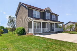 338 Pistole Road Sparta, TN 38583 - Photo 3 of 39 a front view of a house with a garden and yard