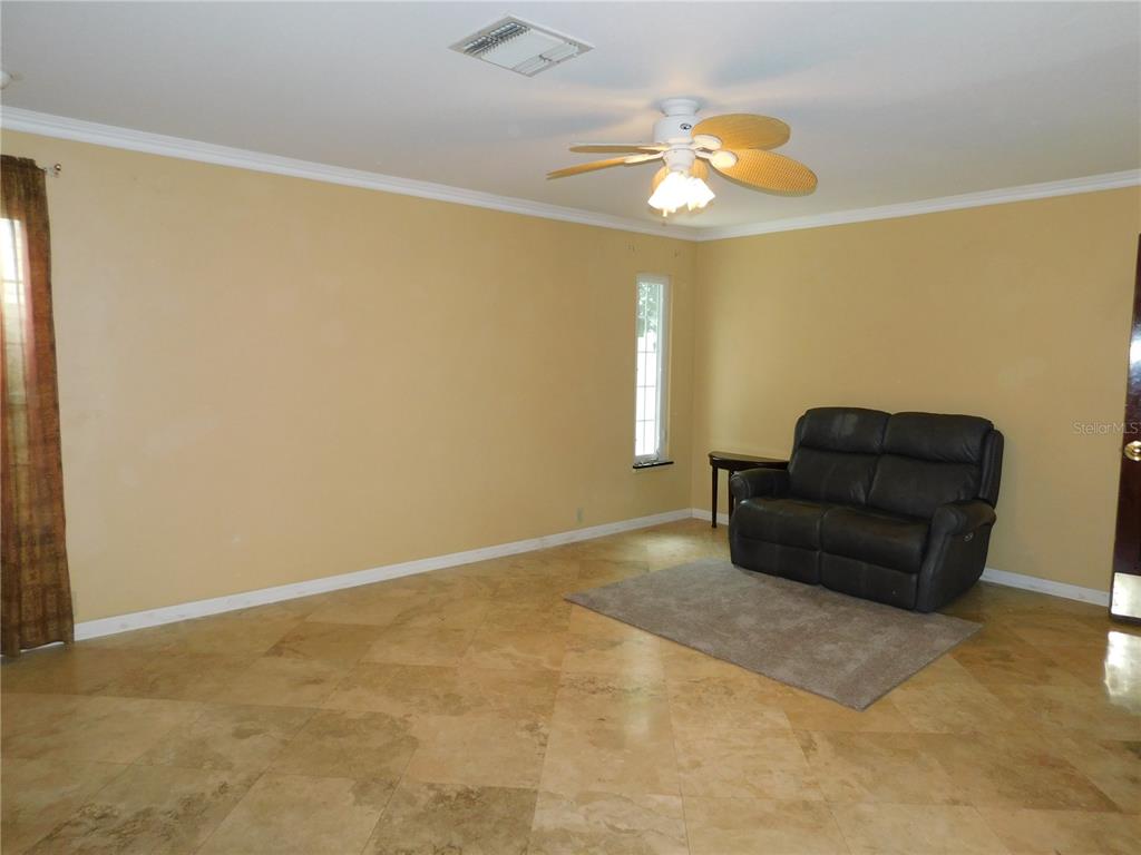 155 Marshall Street Safety Harbor, FL 34695 - Photo 13 of 62 a living room with furniture and a chandelier