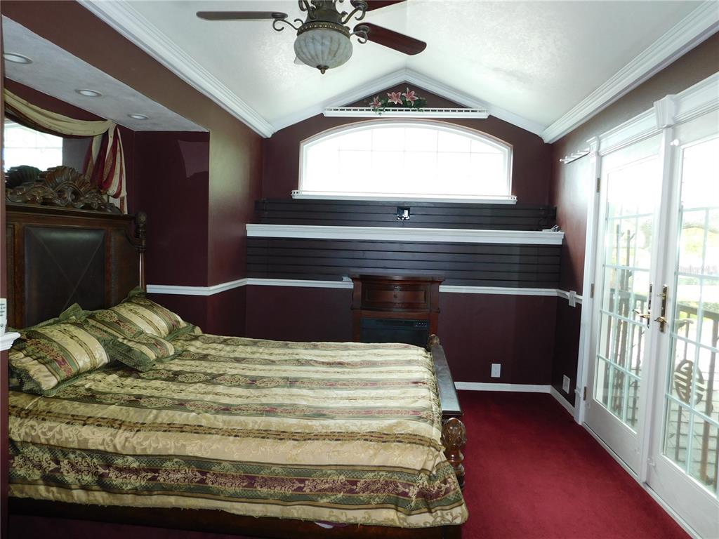 155 Marshall Street Safety Harbor, FL 34695 - Photo 15 of 62 a bedroom with a bed and a chandelier