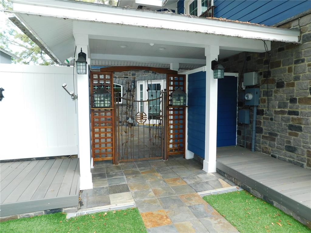 155 Marshall Street Safety Harbor, FL 34695 - Photo 58 of 62 a view of a porch with a table and chairs and potted plants