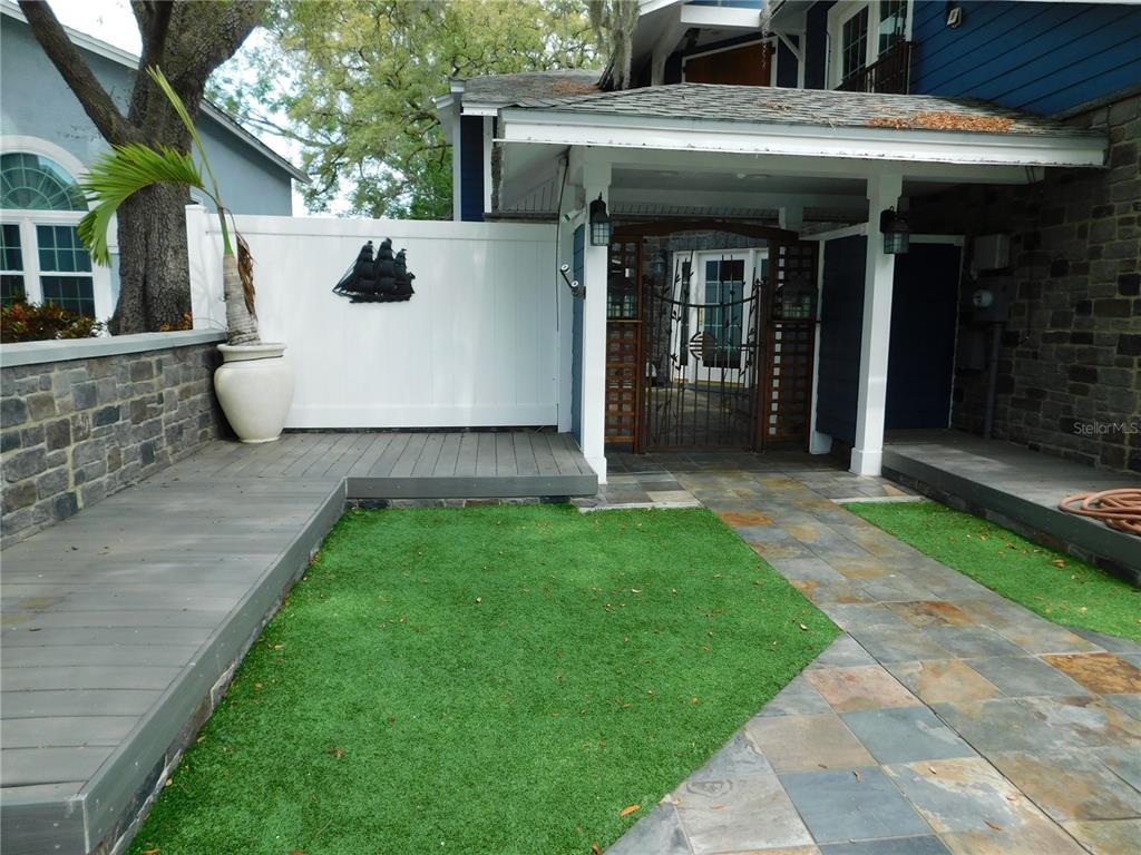 155 Marshall Street Safety Harbor, FL 34695 - Photo 59 of 62 a view of a white house with a small yard and large tree