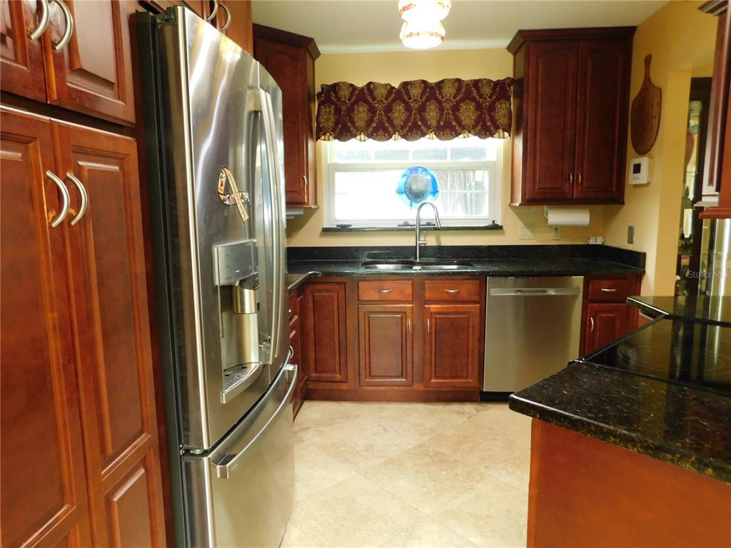 155 Marshall Street Safety Harbor, FL 34695 - Photo 7 of 62 a kitchen with stainless steel appliances granite countertop a refrigerator and a sink