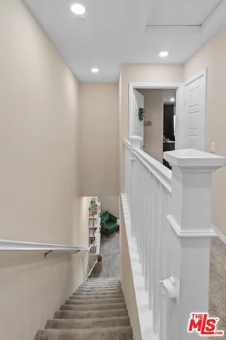 a hallway with a white walls and wooden floor