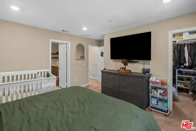 a bedroom with furniture and a flat screen tv
