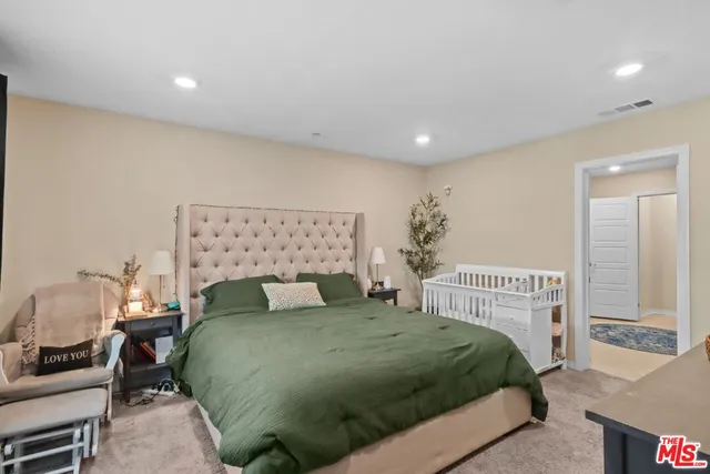 a bedroom with a bed and a chair