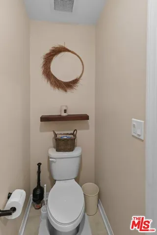 a white toilet sitting next to a bathroom sink