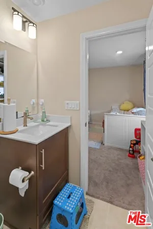 a bathroom with a sink vanity and a mirror